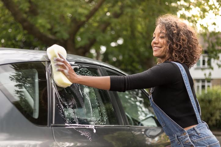 young woman washing car